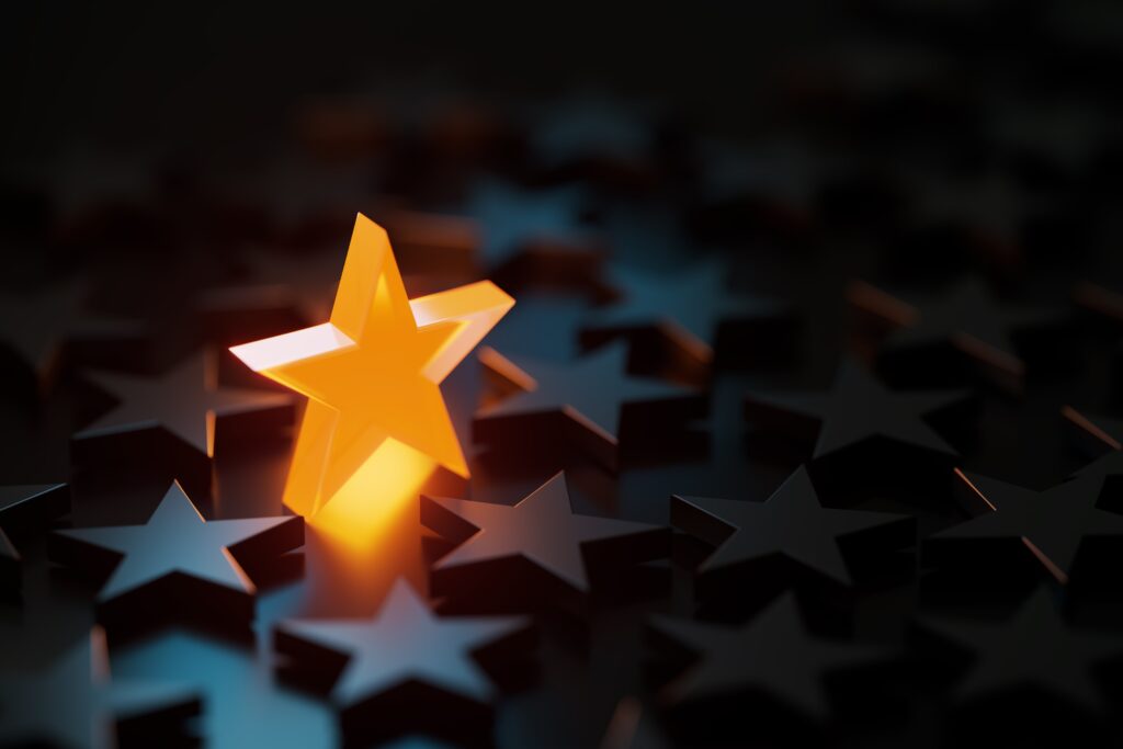A glowing star standing out among dark stars, symbolizing the pressure of perfectionism and the desire to be seen.