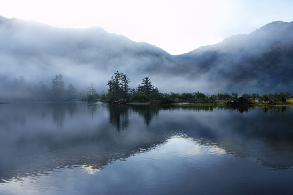 Still mountain lake symbolizing nervous system regulation and trauma therapy in Calgary